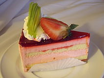 A slice of strawberry cake with garnishing of strawberry