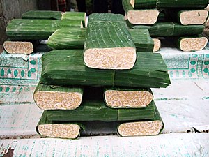 Picture showing fresh tempeh at the market in Jakarta, Indonesia – traditionally wrapped in banana leaves
