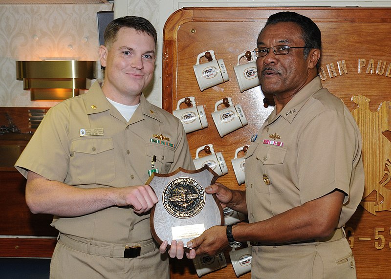 File:US Navy 091117-N-0569T-034 The Surface Warfare Officer of the Year award is presented to Lt. Cmdr. Jeffrey Tamulevich, left, by Vice Adm. D. C. Curtis, commander, Naval Surface Forces, aboard the guided-missile destroyer USS Jo.jpg