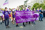A group of people holding an asexual pride banner