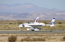 EZ-Rocket, flown by Dick Rutan, touches down at California City, California on December 3, 2005, setting a point-to-point distance record for rocket-powered, ground-launched aircraft. Xcor-ezrocket-N132EZ-051203-63-16.jpg