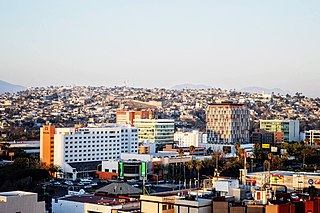 Tijuana is the largest city of both Baja California State and the Baja California Peninsula. It is part of the San Diego–Tijuana transborder urban agglomeration and the larger Southern California megalopolis. As the 6th-largest city in Mexico and center of the 6th-largest metro area in Mexico, Tijuana exerts a strong influence in education and politics – across Mexico, in transportation, culture and art – across all three Californias, and in manufacturing and as a migration hub – across the North American continent. Currently one of the fastest-growing metropolitan areas in Mexico, Tijuana maintains GaWC 'sufficiency city' status. As of 2015, the city of Tijuana had a population of 1,641,570.