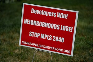 A lawn sign reads, "Developers Win, Neighborhoods Lose! Stop MPLS 2040"