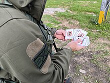 IDF soldier holding a package of Hamas most wanted cards. qlpy mbvqSHy hKHmAs.jpg