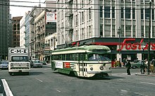 A streetcar passing a Foster's in San Francisco in 1970 1008 Mission and First apr1970 - Flickr - drewj1946.jpg