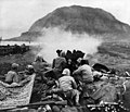 37mm Gun fires against cave positions in north face of volcano in support of RCT 28. These light but extremely accurate weapons did some of their best work in the southern part of the island