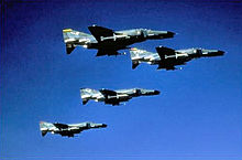 F-4G Phantom II formation from the 37th Tactical Fighter Wing, 561st TFS (yellow tail) 562nd TFTS (blue tail) 563rd (red tail) and Wing Commander (rainbow tail), 1982 561st Tactical Fighter Squadron - F-4G Phantom II formation.jpg