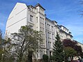 Apartment building in a formerly closed development, with a front yard and enclosure wall