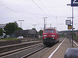 A class 225 locomotive drives through the station