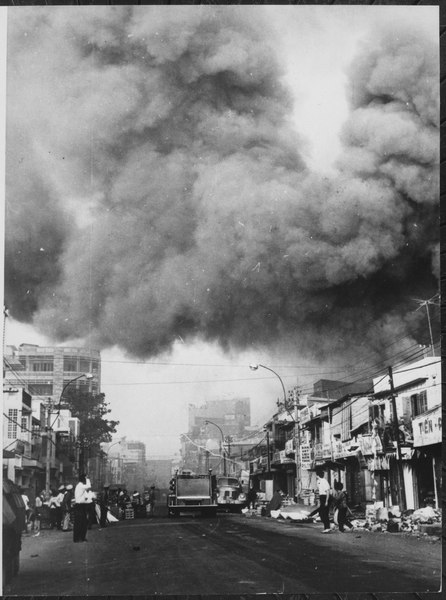 Black smoke covers areas of the capital city and fire trucks rush to the scenes of fires set during attacks by the Viet - NARA - 541874