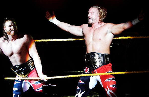 One-time champions Blake and Murphy (right and left), shown here with the original NXT Tag Team Championship belts