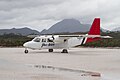 Britten-Norman BN-2 Islander on the Melaleuca Airstrip with Mount Rugby behind, Southwest Conservation Area, Tasmania, Australia