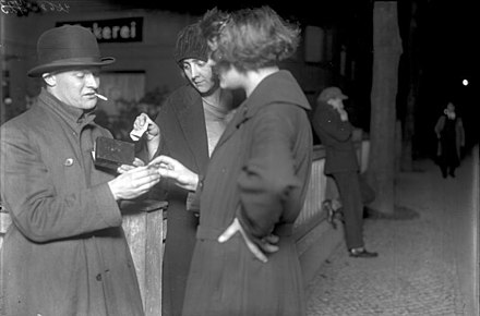 Prostitutes buy cocaine capsules from a drug dealer in Berlin, 1930. The capsules sold for 5 marks each.