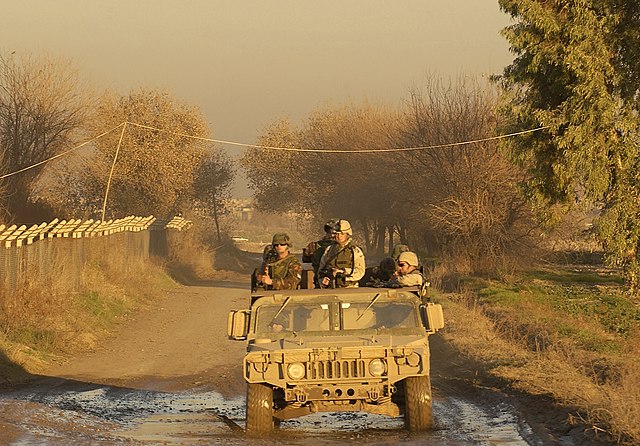 Albanian soldiers conduct a joint patrol with U.S. soldiers in Iraq on 13 January 2005