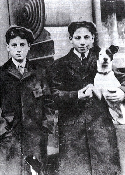 Julius Henry Marx (Groucho, left) and Adolph Marx (Harpo) holding a rat terrier dog, c. 1906