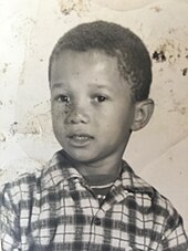 A black and white photo of James Herbert Williams wearing a plaid shirt when he was in the third grade