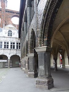 Dolga hiša s trga: renesančni granitni stebri nosijo gotski zid iz glazirane opeke