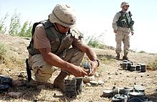 A U.S. Army Explosive Ordnance Disposal technician removing the fuze from a Russian-made mine to clear a minefield outside of Fallujah, Iraq Mine sweep.jpg