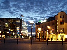 Sanomatalo on the background on the left. On the foreground of the left is Postitalo and on the right is the Czech restaurant Vltava. Mittsommernacht-in-helsinki.jpg