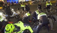 Strategic Response Group bicycle officers tackling a man at a protest against police brutality and gun violence in March 2018 NYPD Strategic Response Group - Police Brutality Protest - March 28, 2018.png