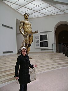 Olivia Tennet in front of a statue of Hercules.jpg