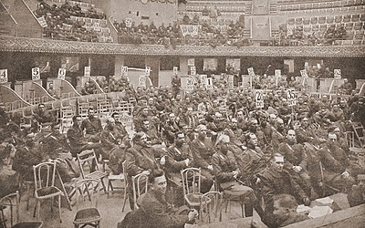 Photograph taken by a photographer who slipped in a half-hour before the session began, with more than half the Paris caucus delegates absent Paris Caucus (March 1919).jpg