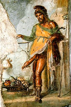 Priapus, wearing a Phrygian cap and weighing his phallus in a balance scale (House of the Vettii, Pompeii)