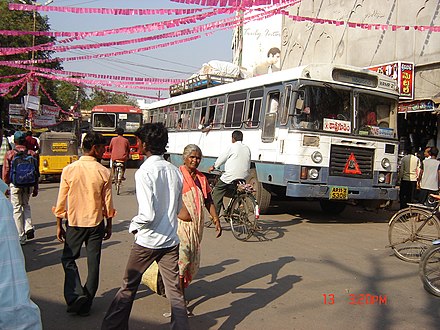 Busy center and bus stop at railway station, looking toward Bus Stand Road