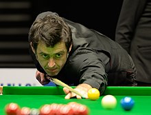 snooker player playing a shot