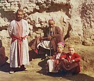 Two Sart men and two Sart boys in Samarkand, c. 1910 Sartscrop.jpg