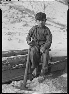 Barefoot miner's child digging coal from mine refuse on the roadside (December 23, 1936) Scott's Run, West Virginia. Miner's child - This boy was digging coal from mine refuse on the road side. The picture... - NARA - 518366.jpg
