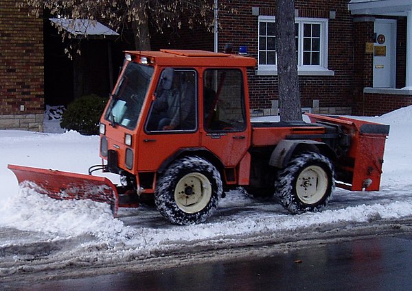 A small sidewalk clearing plow in Ottawa, Ontario, Canada
