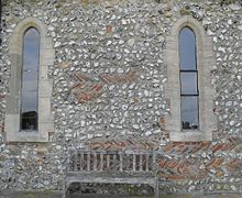 The south wall of the chancel has ancient herringbone pattern brickwork using Roman bricks. St George's Church, Eastergate (Herringbone Brickwork).JPG