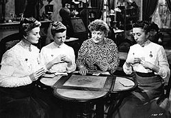 Mandy (Florence Bates, second from right) teaches the Cheever sisters (from left: Moyna MacGill, Irene Ryan, and Margaret Hamilton) how to play poker. Texas, Brooklyn and Heaven (1948) 2.jpg
