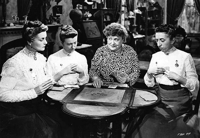 Mandy (Florence Bates, second from right) teaches the Cheever sisters (from left: Moyna MacGill, Irene Ryan, and Margaret Hamilton) how to play poker.