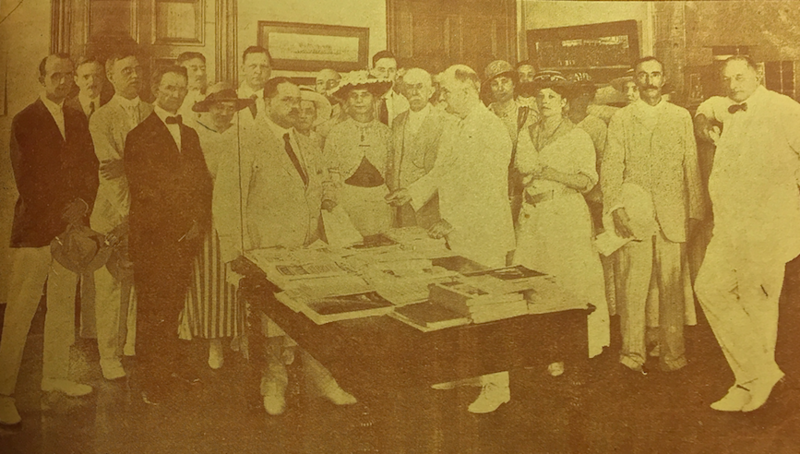 File:US Consul General Sammons handing cheque to E.I Ezra.png