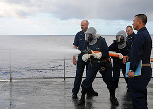 US Navy 120114-N-BK465-059 Sailors assigned to the submarine tender USS Frank Cable (AS 40) practice hose handling techniques on the flight deck du.jpg