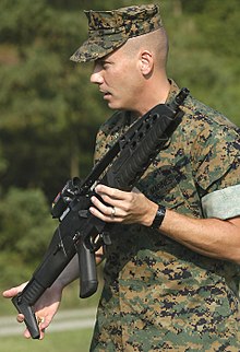 A U.S. Marine Corps weapons instructor presents an XM8 Carbine during the Infantry Operations Chief Symposium in August 2005. XM8 and Marine.jpg