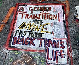 Street art that reads: "A Gender Transition is Divine — Protect Black Trans Life"