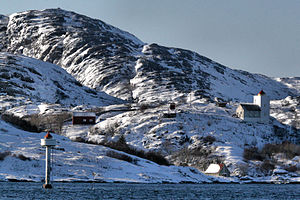 Agdenes fyr on a hill and the new beacon in the foreground