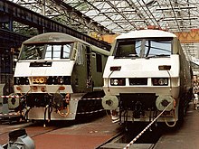 A Class 90 (90050) and a Class 91 (91020) under construction at Crewe Works in 1990