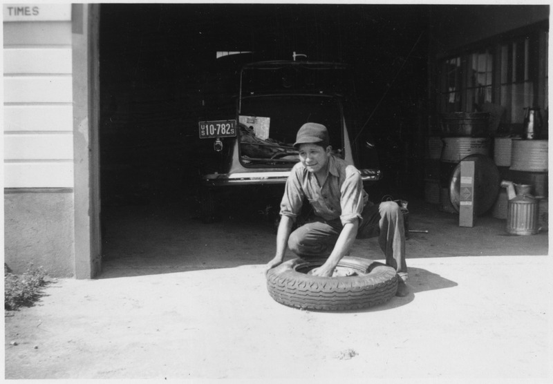 File:Emmet Jones, former CCC enrollee, working on tire - NARA - 285887.tif