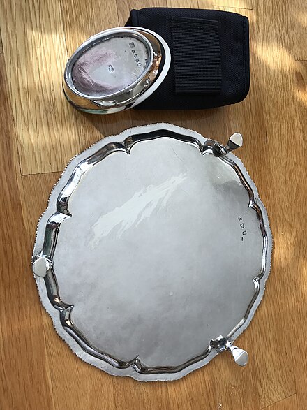 These two pieces of hallmarked English silver show assay "scrapes," where a small amount of silver was removed from the underside of the item in order to perform a fire assay. The 10 3/4" salver (Richard Rugg, 1759) shows a large scrape. The salt cellar (Robert & Samuel Hennell, 1803) has a much smaller  scrape - however the cellar was from a set of at least four, allowing for scrapes to be combined.