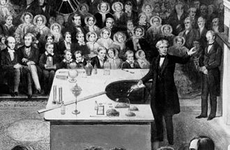 Michael Faraday presenting his experiments with electromagnetism at a Christmas Lecture, 1856 Faraday Michael Christmas lecture detail.jpg