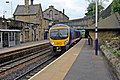 A First TransPennine Express Class 185 passes through the station.