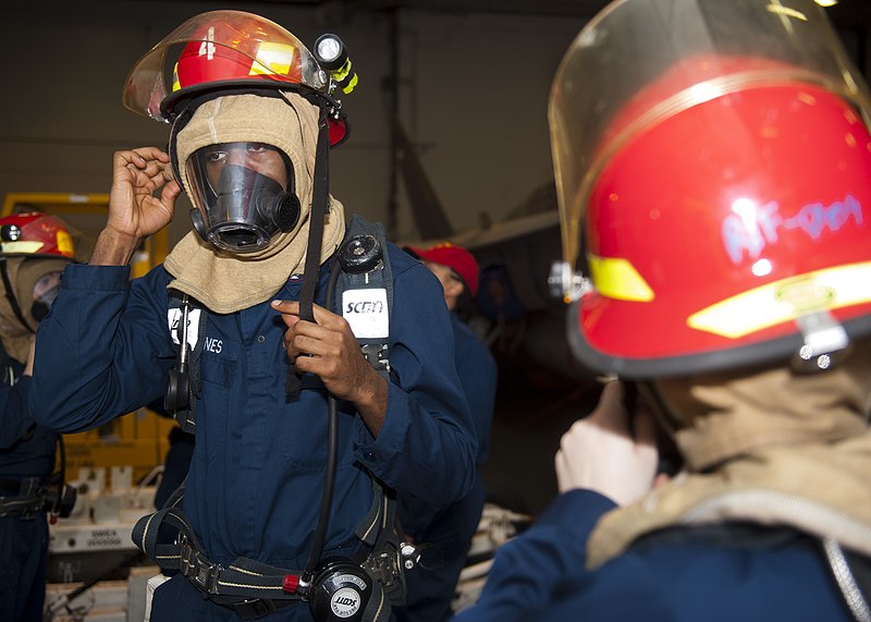 File:Flickr - Official U.S. Navy Imagery - A Sailor dons a firefighting helmet..jpg