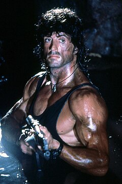 Sylvester Stallone as Rambo, holding a gun