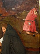 書を手に熟考する聖アントニウスと赤マントの小人