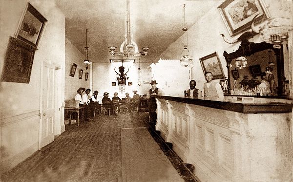 Photo of the interior of the Long Branch Saloon in Dodge City, Kansas, taken between 1870 and 1885