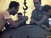 The two physicists Harry Daghlian (center left) and Louis Slotin (center right) during the Trinity Test. Both died following supercriticality accidents involving the "demon core." Louis Slotin & Harry K. Daghlian Jr.jpg